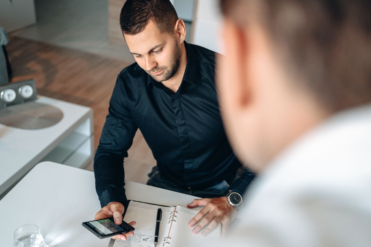 Insurance professional checking a lesson on their smartphone between calls